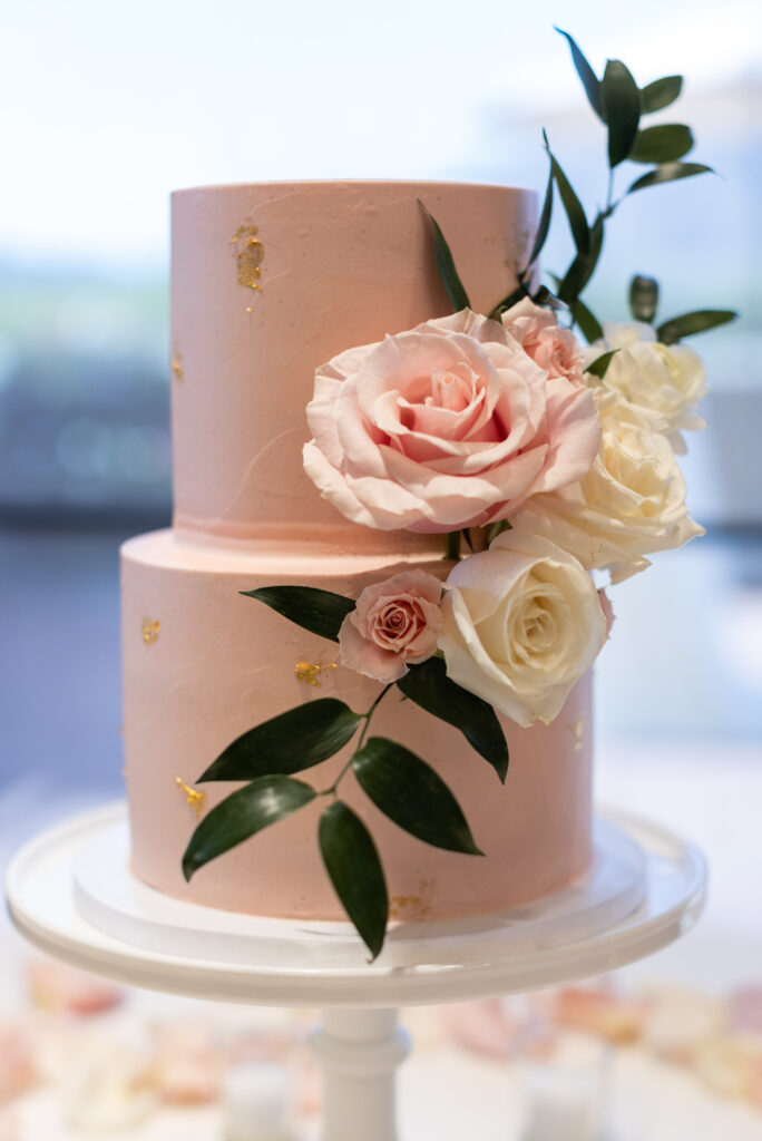 Designing Your Wedding - Pink wedding cake with flowers and greenery