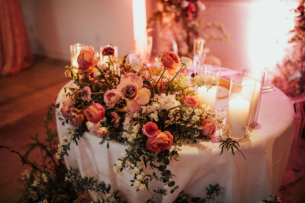 Sweetheart table with florals and candlelight